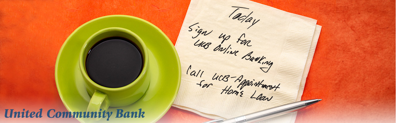 Cup of coffee with a napkin note to sign up for online banking.